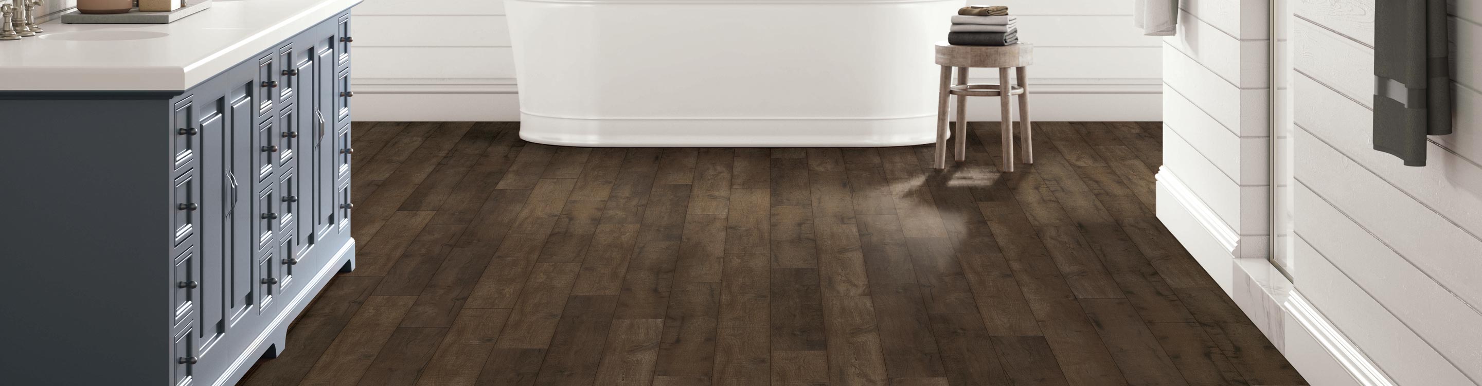 dark laminate flooring in kitchen with island and stools